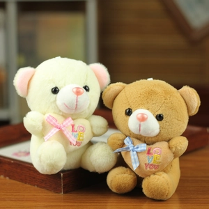 Detail of plush teddy bears with embroidered hearts and bows for keychains