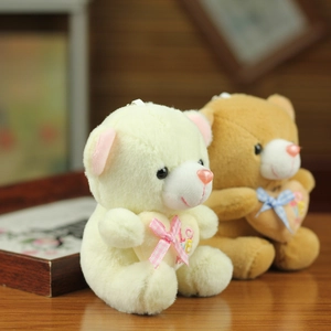Detail of plush bear keychains in cream and light brown with LOVE heart pillows