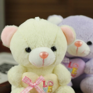 Close-up of cute plush bears with heart embroidery and soft texture detail