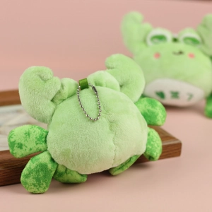 Detail of cute green plush crab keychain with soft texture and silver ball chain