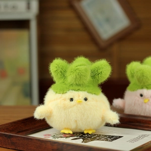 Detailed close-up of a cute yellow chick plush keychain with green leaf decorations