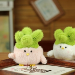 Close-up of cute plush cabbage chick keychains in soft pink and white faux fur