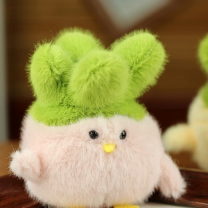 Close-up of soft pink plush chick toy with green sprout detail and fluffy texture
