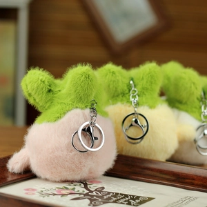 Close-up of soft fluffy pineapple plush keychains with silver lobster clasps in various colors
