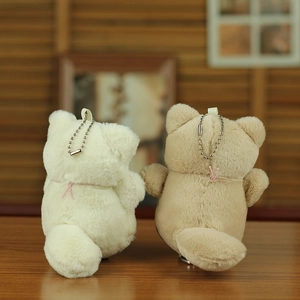 Cute plush bear charms in beige and khaki with silver ball chains on wood surface