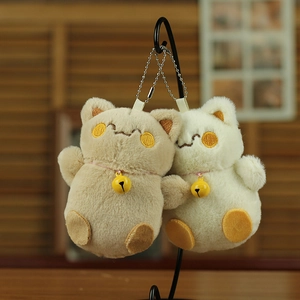 Detail of plush cat keychains featuring soft fur texture and cute bell ornaments