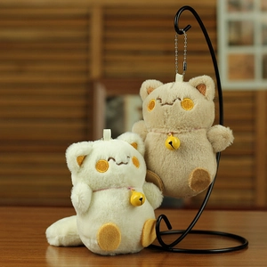 Close-up of cute plush cat keychains with embroidery details and small yellow bells