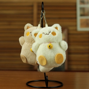 Close-up of cute plush cat keychains with soft faux fur and small golden bells