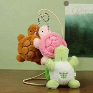 Cute plush turtle keychain charms in various colors hanging on a minimal stand