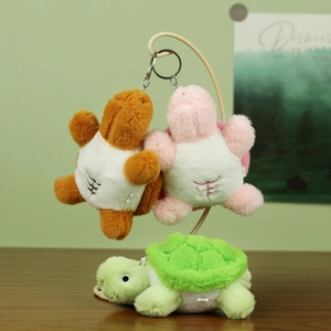 Detailed view of plush turtle keychains in three colors with abdominal muscle embroidery