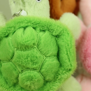 Macro shot of green plush turtle shell stitching with premium metal keychain hook
