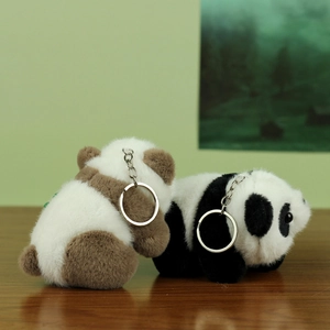 Close-up of plush panda keychains in black and brown fur with durable metal rings