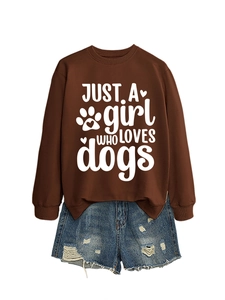Detail of a brown sweatshirt with JUST A girl WHO LOVES dogs text and denim shorts