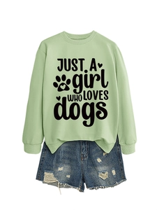 Detail of light green sweatshirt with Just a girl who loves dogs print and denim shorts