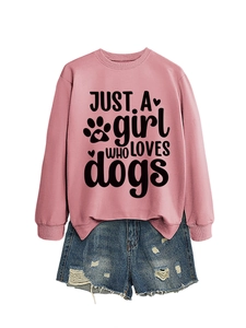 Detail of pink sweatshirt with 'JUST A girl WHO LOVES dogs' print and denim shorts