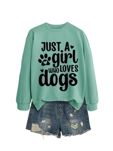 Detail of mint green sweatshirt with 'JUST A girl WHO LOVES dogs' print and denim shorts