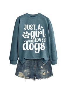 Detail of blue crewneck sweatshirt with dogs print paired with denim shorts