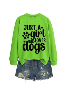 Flat lay of neon green sweatshirt with dog lover text and distressed denim shorts
