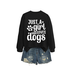 Black 'JUST A GIRL WHO LOVES' sweatshirt paired with distressed denim shorts on white background