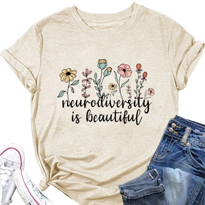 Detailed close-up of beige T-shirt featuring neurodiversity is beautiful floral print
