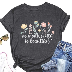 Flat lay of charcoal grey t-shirt with floral neurodiversity is beautiful print and knotted hem