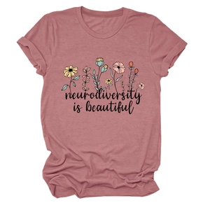 Detail of rolled sleeves and floral neurodiversity print on a rose pink crew neck T-shirt