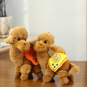 Detailed close-up of cute plush camel keychain with traditional colorful saddle embroidery