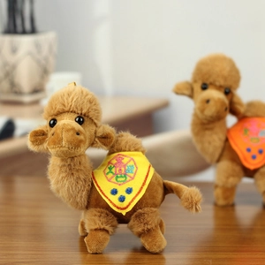 Close-up of brown plush camel keychain featuring detailed ethnic embroidery on yellow saddle
