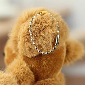 Close-up of a silver metal bead chain connector on a brown plush camel keychain toy