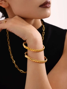 Polished 18K gold-plated beaded bangle set and chunky chain necklace on model