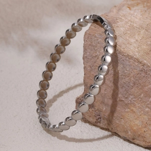 Polished silver beaded bangle bracelet with minimalist metallic ball design in 18K finish