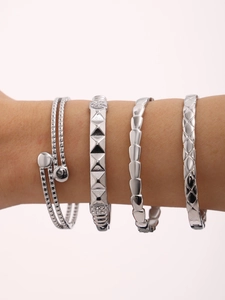 Detail of four-piece silver stainless steel bracelet set with diverse textured patterns