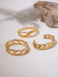 Close-up of three 18K gold-plated bracelets featuring infinity design and chain texture