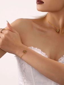 Detalle de un conjunto de joyas de copo dorado con circonitas multicolores usado por modelo