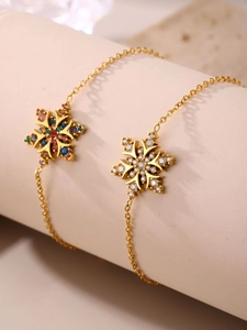 Detalle macro de pulseras de copo de nieve bañadas en oro 18K con circonitas de colores