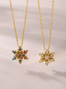 Macro-detail van gouden sneeuwvlok hangers met kleurrijke en heldere zirkonia kristallen