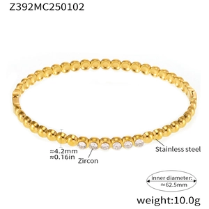 Detail view of gold stainless steel bangle with zircon inlay and product dimensions