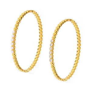 Gold-plated hoop earrings with small beads, pearls, and zircons on a white background