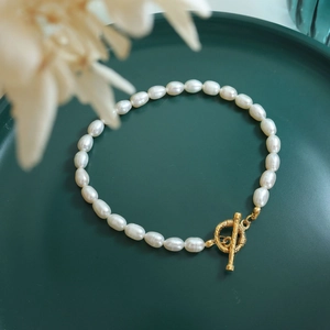 Detailed view of Baroque freshwater pearl bracelet with textured golden OT toggle clasp