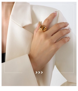 Detailed view of vintage gold ring with square tiger eye stone on model hand