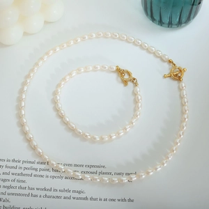 Close-up of freshwater pearl necklace and bracelet set with golden OT toggle clasp