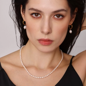 Baroque freshwater pearl jewelry set with OT buckle necklace and drop earrings on a model