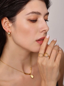Detail shot of 18K gold plated set featuring infinity ring with colorful zircon accents