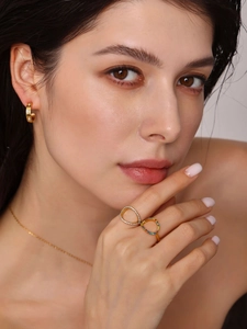 Model wearing gold jewelry set with colorful zirconia open ring and C-shaped earrings
