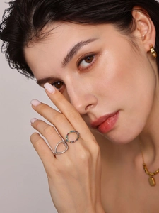 Close-up of model wearing adjustable hollow teardrop ring with colorful zircons