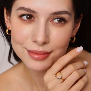 Adjustable hollow gold ring with rainbow cubic zirconia stones worn with jewelry set