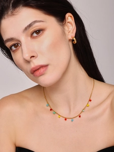 Close-up of heart-shaped crystal pendants on a gold chain necklace for women