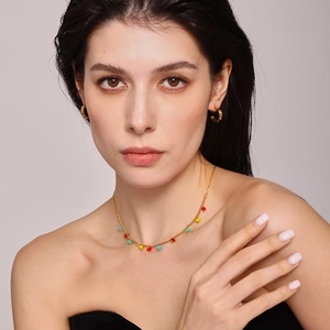 Gold stainless steel heart necklace and C-shaped earrings set on a model