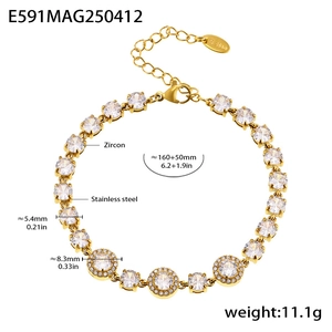Detail view of gold stainless steel bracelet showing lobster clasp and zircon charms