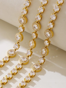 Macro shot of gold tennis bracelets featuring round 5A zircon halo and prong settings